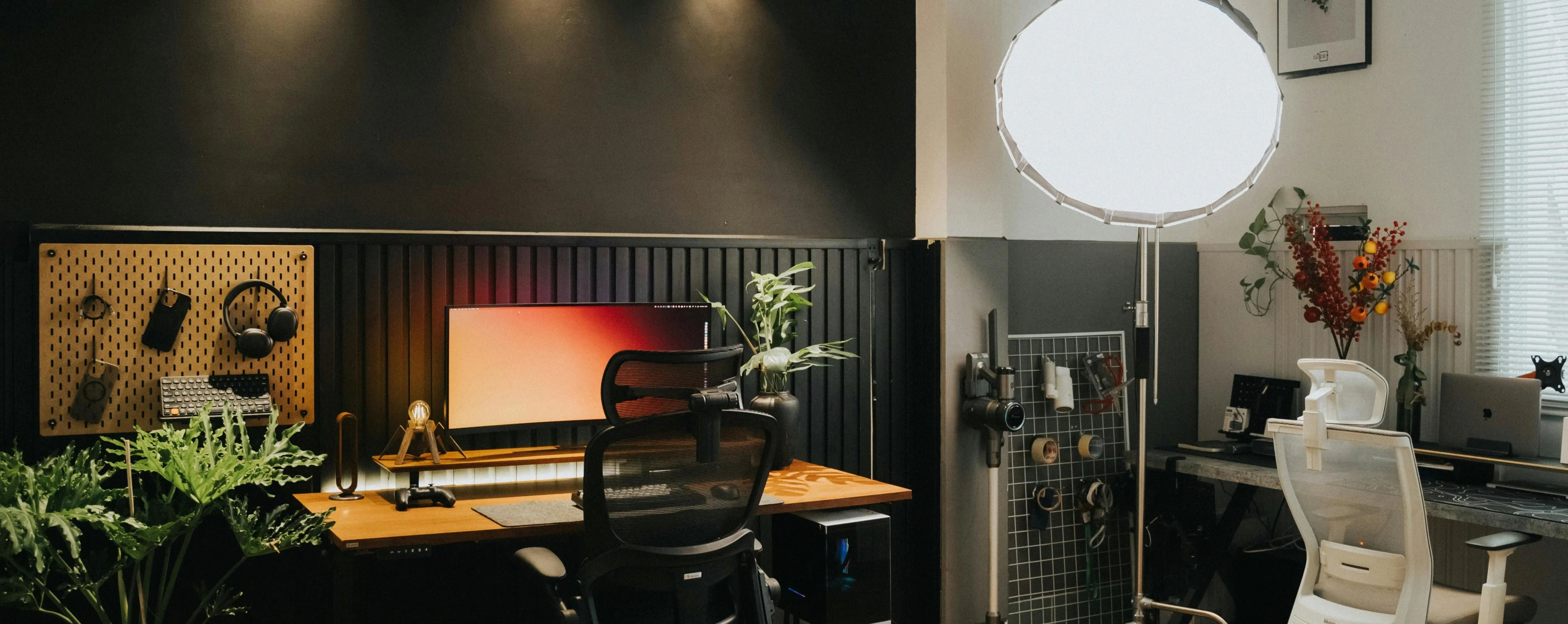 Modern home office with desk, chairs, and decorative elements.
